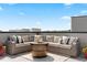 Relaxing rooftop patio with comfortable seating, a fire pit, and scenic views at 12261 Farmview St, Thornton, CO 80241