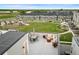 Luxurious rooftop patio boasts a comfortable seating area with a fire pit, a dining set, and amazing community views at 12261 Farmview St, Thornton, CO 80241