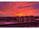 Rooftop view of fiery sunrise sky over suburban neighborhood at 12261 Farmview St, Thornton, CO 80241