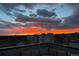 An amazing sunset view over a city neighborhood, featuring a beautiful, colorful sky with rooftops and clouds at 12261 Farmview St, Thornton, CO 80241
