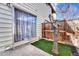 Sliding glass door opens onto a small grass patch with a privacy fence at 3502 S Kittredge St # C, Aurora, CO 80013