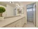 Bathroom featuring white cabinetry, a large mirror, tiled flooring, and the shower at 3502 S Kittredge St # C, Aurora, CO 80013