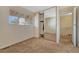 Inviting bedroom featuring carpet flooring, a closet with mirror doors, and a window at 3502 S Kittredge St # C, Aurora, CO 80013