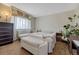 Bedroom featuring carpet flooring, a bed, and a window with curtains at 3502 S Kittredge St # C, Aurora, CO 80013