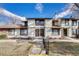 Charming multi-level condo featuring a neutral color scheme, brown accents, and well-manicured landscaping at 3502 S Kittredge St # C, Aurora, CO 80013