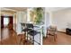 View of the kitchen passthrough to seating area with black bar stools, wood-look floors, and white walls at 3502 S Kittredge St # C, Aurora, CO 80013