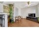Living room with ceiling fan, passthrough to kitchen, entertainment center and wood look floors at 3502 S Kittredge St # C, Aurora, CO 80013
