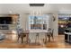 Bright dining room with wood table and chairs, hardwood floors, and large windows at 1861 W 34Th Ave, Denver, CO 80211