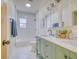 Bathroom featuring a double sink vanity, hexagon tile floors, and tub with white subway tile at 541 Fox St, Denver, CO 80204