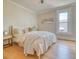 Bright bedroom featuring a large bed with soft linens, wood floors, and a window with natural light at 541 Fox St, Denver, CO 80204