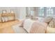 Bedroom featuring bed with neutral linens, wood floors, and large windows for natural light at 541 Fox St, Denver, CO 80204