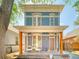 Charming two-story home with a covered front porch and vibrant blue brick exterior at 541 Fox St, Denver, CO 80204