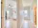 Hallway with wood floors leading to a bedroom featuring a bed with ceiling fan and natural light from the windows at 541 Fox St, Denver, CO 80204