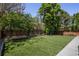 Artificial turf, mature trees and a small sandbox define this landscaped private backyard at 420 N Colorado Blvd, Denver, CO 80206
