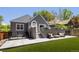 Gray home with an outdoor living space including outdoor seating and artificial turf in the backyard at 420 N Colorado Blvd, Denver, CO 80206