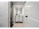 A modern bathroom with a sink, vanity, and a glass-enclosed shower with sleek, black fixtures at 420 N Colorado Blvd, Denver, CO 80206