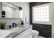 Modern bathroom featuring a marble countertop vanity, unique brick wall accent, and a sleek, updated design at 420 N Colorado Blvd, Denver, CO 80206