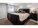 Comfortable bedroom featuring a sleek, dark-colored sleigh bed frame and natural lighting at 420 N Colorado Blvd, Denver, CO 80206