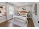 Comfortable bedroom with hardwood floors, a plush bed, and stylish decor, creating a relaxing and inviting space at 420 N Colorado Blvd, Denver, CO 80206