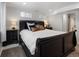 Comfortable bedroom featuring a sleek, dark-colored sleigh bed frame and natural lighting at 420 N Colorado Blvd, Denver, CO 80206
