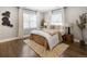 Bright bedroom with hardwood floors, two large windows, neutral walls, and a comfortable bed at 420 N Colorado Blvd, Denver, CO 80206