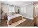 Sunlit bedroom featuring hardwood floors, neutral decor, and a cozy bed with ample natural light at 420 N Colorado Blvd, Denver, CO 80206