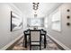 Bright dining room with modern light fixture, neutral walls, and elegant black table set on a patterned rug at 420 N Colorado Blvd, Denver, CO 80206