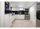 This kitchen features white cabinets, stainless steel appliances, and black tile backsplash at 420 N Colorado Blvd, Denver, CO 80206
