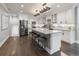 Open kitchen with a large island with bar stool seating, stainless steel appliances, and stone countertops at 420 N Colorado Blvd, Denver, CO 80206
