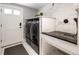 Functional laundry room with modern washer and dryer, white marble countertops, and a pet wash station at 420 N Colorado Blvd, Denver, CO 80206