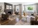 Inviting living room with a stone fireplace, hardwood floors, large windows, and comfortable seating at 420 N Colorado Blvd, Denver, CO 80206