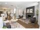 Open-concept living room with stone fireplace, plush seating, hardwood floors, and an adjoining kitchen area at 420 N Colorado Blvd, Denver, CO 80206