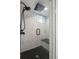 A glass enclosed shower with a sleek rainfall shower head and black accent features at 420 N Colorado Blvd, Denver, CO 80206