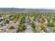 An aerial view captures the neighborhood, revealing rooftops, verdant trees, and a scenic mountain backdrop at 3102 White Oak Trl, Highlands Ranch, CO 80129