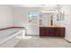 Bathroom featuring a large tub, a large window, a vanity with granite counters, and carpet flooring at 3102 White Oak Trl, Highlands Ranch, CO 80129