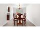 Formal dining room features a wood table, six chairs, and a view to the outside at 3102 White Oak Trl, Highlands Ranch, CO 80129