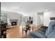 Inviting living room with hardwood floors, fireplace and a seamless transition to the kitchen and dining area at 3102 White Oak Trl, Highlands Ranch, CO 80129