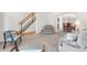 Bright living room showcasing neutral carpet, staircase and an archway leading to the dining area at 3102 White Oak Trl, Highlands Ranch, CO 80129