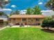 Expansive backyard featuring a patio, green lawn, and mature trees, perfect for outdoor living at 1811 S Yank Ct, Lakewood, CO 80228