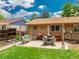 Well-maintained backyard with patio, dining area, green lawn, and privacy fence at 1811 S Yank Ct, Lakewood, CO 80228
