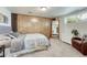 Cozy bedroom with wood paneling, plush carpet, large mirror, and natural light at 1811 S Yank Ct, Lakewood, CO 80228