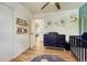 Bedroom offers wood floors and features a crib, dresser, and reading nook at 1811 S Yank Ct, Lakewood, CO 80228