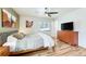 Bedroom with a window, hardwood floors, and dresser with television at 1811 S Yank Ct, Lakewood, CO 80228