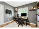 Office space offers natural light, wood floors, and shelving at 1811 S Yank Ct, Lakewood, CO 80228