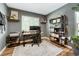 Home office with hardwood floors, large window, and desk at 1811 S Yank Ct, Lakewood, CO 80228
