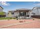 Beautiful backyard with a covered patio and charming rock landscaping, perfect for outdoor entertaining at 3022 Merlin Dr, Brighton, CO 80601
