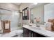 Contemporary bathroom with a sleek vanity, mirrored cabinet, and a shower with a glass sliding door at 3022 Merlin Dr, Brighton, CO 80601