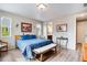 Relaxing bedroom featuring wood floors and a comfortable bench at the foot of the bed at 3022 Merlin Dr, Brighton, CO 80601