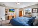 Spacious bedroom with a large window and an entertainment center, offering a relaxing retreat at 3022 Merlin Dr, Brighton, CO 80601