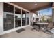 Inviting covered patio featuring a dining set, offering a cozy space for outdoor meals and relaxation at 3022 Merlin Dr, Brighton, CO 80601